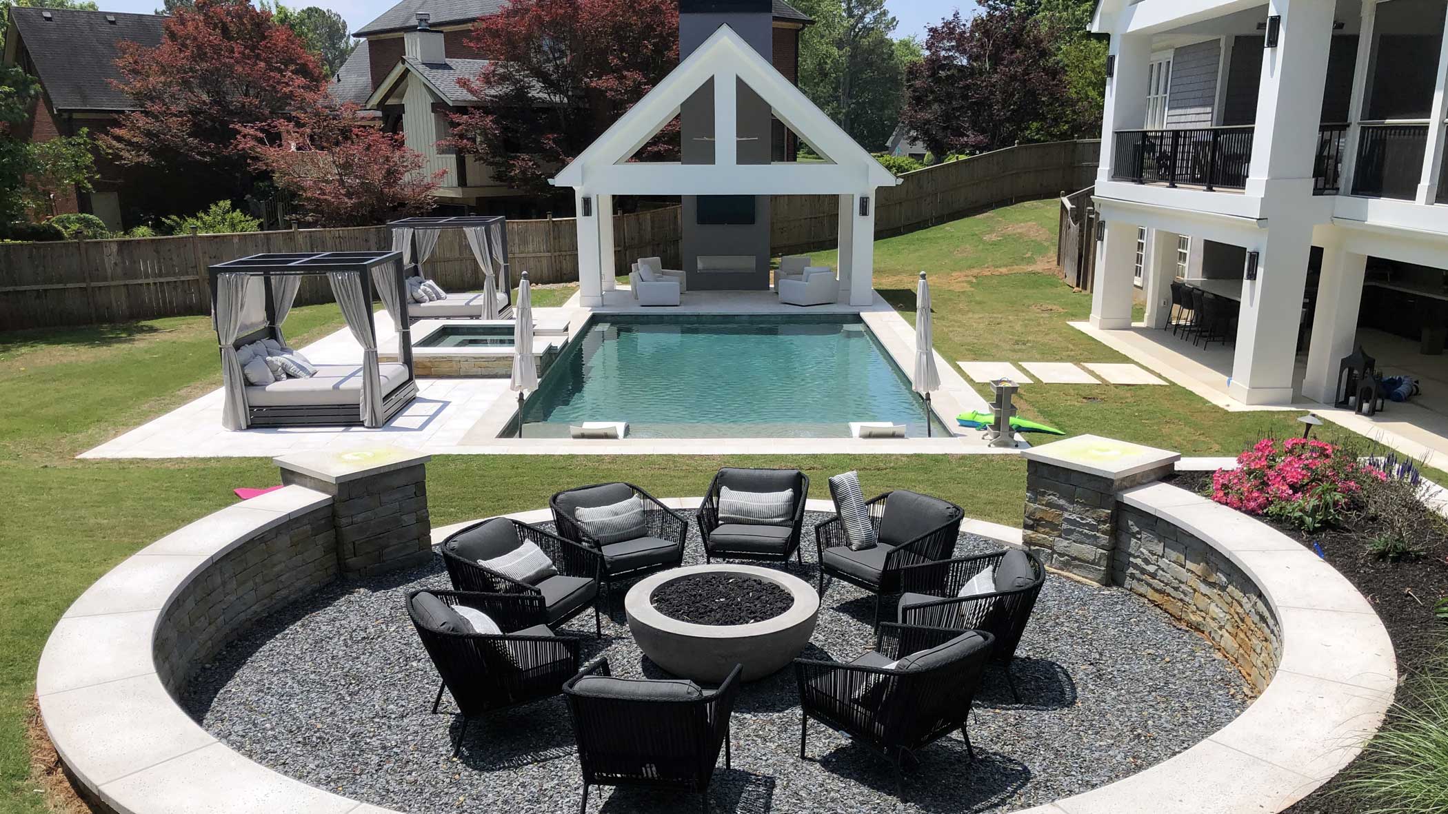 Modern pool, fire pit, outdoor fireplace and landscape design by Living Environments in Roswell